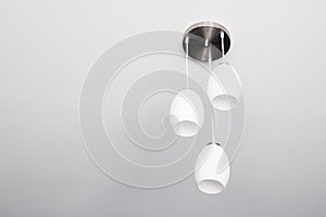 Decorative ceiling light with bare wall and copy space.