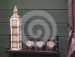 Decorative ceramic clock tower and cups in the interior of pub