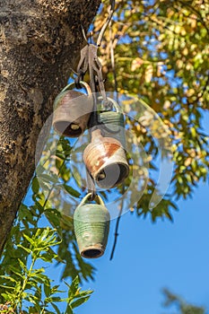 Decorative ceramic cowbells isolated in a tree