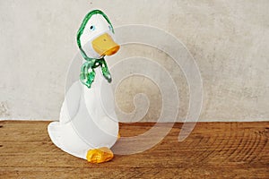 Decorative ceramic duck interior decor on wooden background