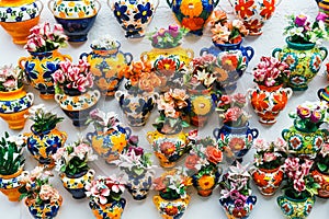 Decorative ceramic plates and pots of colorful flowers in the historic Albaicin neighbourhood.