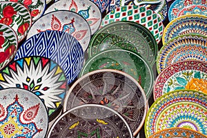 Decorative ceramic plates with traditional uzbek ornament in the street market of Bukhara. Uzbekistan