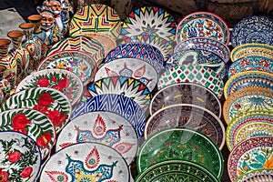 Decorative ceramic plates with traditional uzbek ornament in the street market of Bukhara. Uzbekistan