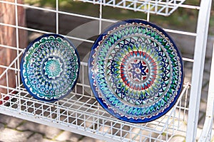 Decorative ceramic plates with traditional uzbek ornament in the street market of Bukhara. Uzbekistan