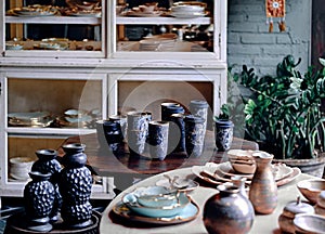 Decorative ceramic set in the interior home. Showcase of handmade ceramic pottery