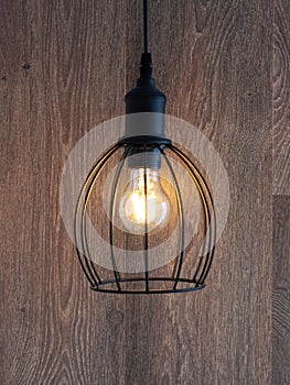 Decorative chandelier on a background of a wooden wall.