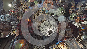 Decorative chandeliers at turkish Grand bazaar. Action. Bottom view of amazing lamps made of colorful glass, concept of
