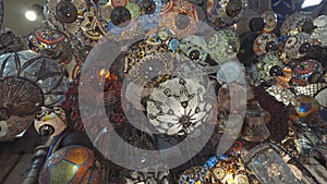 Decorative chandeliers at turkish Grand bazaar. Action. Bottom view of amazing lamps made of colorful glass, concept of