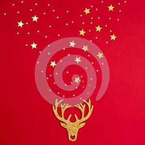 Decorative Christmas decorations deer on a red background with gold stars sparkles