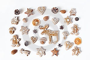 Decorative Christmas food pattern. Winter composition of gingerbread cookies, anise stars, pine cones and dry orange