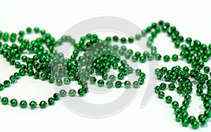 Decorative Christmas green beads for Christmas tree close up on white background. Beautiful green beads. Festive decoration. Selec