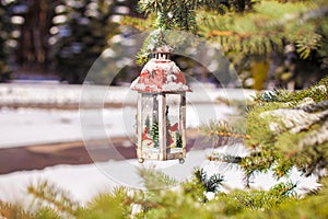 Decorative Christmas lantern on fir branch in snow