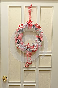 Decorative Christmas ornaments on a white front door. Toning