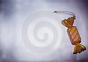 Decorative Christmas toy candy lies on  silver background