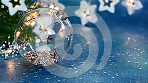 Decorative christmas tree glass ball on background of glowing christmas lights