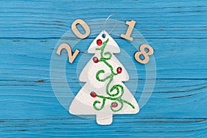 Decorative christmas tree and numbers 2018 new year on blue wooden old table