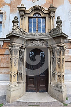Decorative classicistic house gate on old decaying historical town house in Esztergom, Hungary.