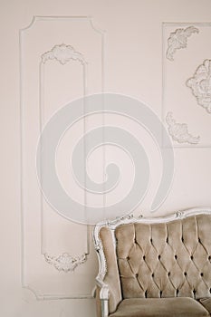 Decorative clay stucco relief molding with ornaments on white ceiling in classical style interior with part of vintage