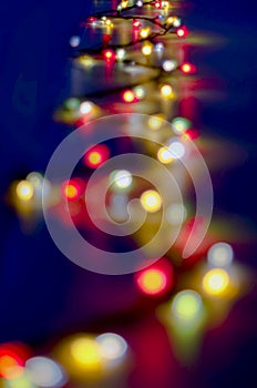 Decorative Colorful Blurred Christmas Lights On Dark Blue Background. Abstract Soft Lights. Colorful Bright Circles Of A Sparkling
