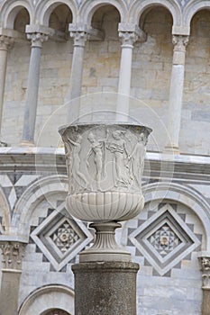 Decorative column on the background of Leaning Tower of Pisa and Pisa Cathedral, Piazza del Duomo, Italy