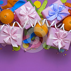 Decorative composition four boxes with gifts Satin ribbon Bow Oranges Confetti Serpentine birthday party. photo