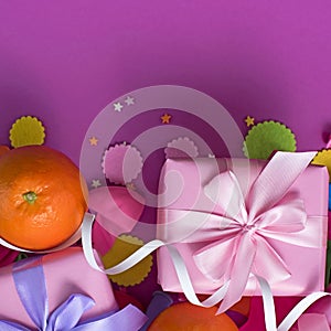 Decorative composition two boxes with gifts Satin ribbon Bow Oranges Confetti Serpentine birthday party. photo