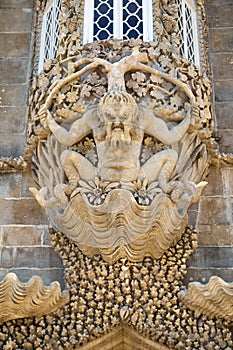 Decorative corbel in form of Triton under the oriel window in Pena Palace. Sintra. Portugal photo