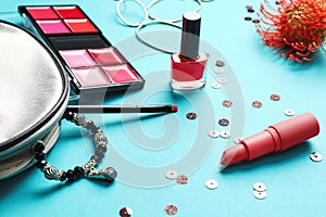 Decorative cosmetics and accessories on color background