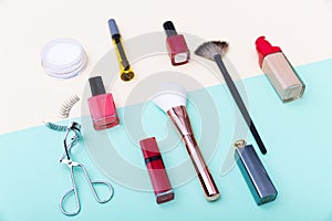Decorative cosmetics, makeup products and brushes on pastel blue color background