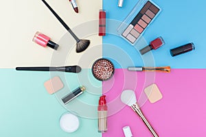 Decorative cosmetics, makeup products and brushes on pastel color background