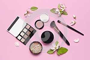 Decorative cosmetics mascara powder lipstick eyeshadow blush balls makeup brush perfume blooming spring branches on pink