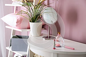 Decorative cosmetics with perfume bottle on white table