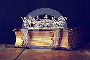 Decorative crown on old book. vintage filtered. selective focus