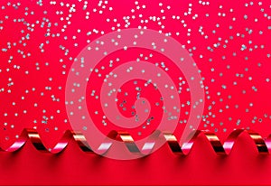 Decorative curled red ribbon isolated on red background decorated silver stars with copy space