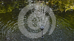 Decorative decoration of watering with water for the garden, spray of a jet and a drop of water in slow motion, pouring