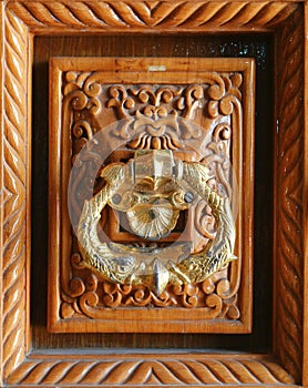Decorative door handle knocker architecture on wood
