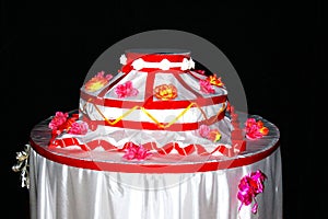 Decorative dummy cake with flowers and red ribbons