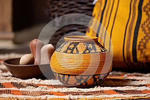 decorative earthenware pot on an african handwoven mat with kinara