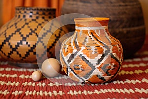 decorative earthenware pot on an african handwoven mat with kinara