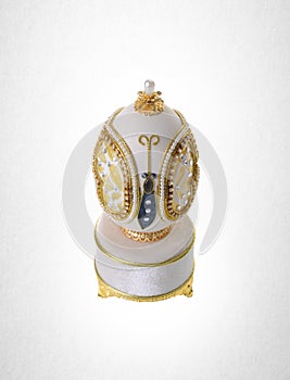 Decorative easter egg for jewellery (Faberge egg) on background.