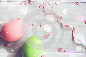 Decorative easter eggs on white wooden background