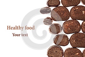 Decorative edging pieces of black rye bread on a white background.