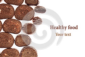 Decorative edging pieces of black rye bread on a white background.