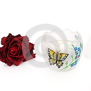 Decorative eggs and dried rose on a white background. Eggs with beautiful painting