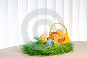 Decorative eggs on green grass. Chicken basket. Concepts Easter, eggs, hand made