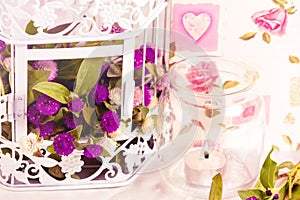 Decorative elements- flowers in cage and candle.