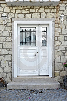 Decorative entrance wooden white door of a nostalgic house in Alacati, Cesme, Izmir, Turkey