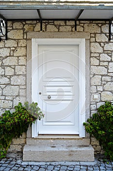 Decorative entrance wooden white door of a nostalgic house in Alacati, Cesme, Izmir, Turkey