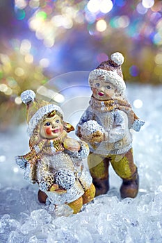 Decorative figures of children playing in a winter fairy forest.