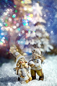 Decorative figures of children playing in a winter fairy forest.